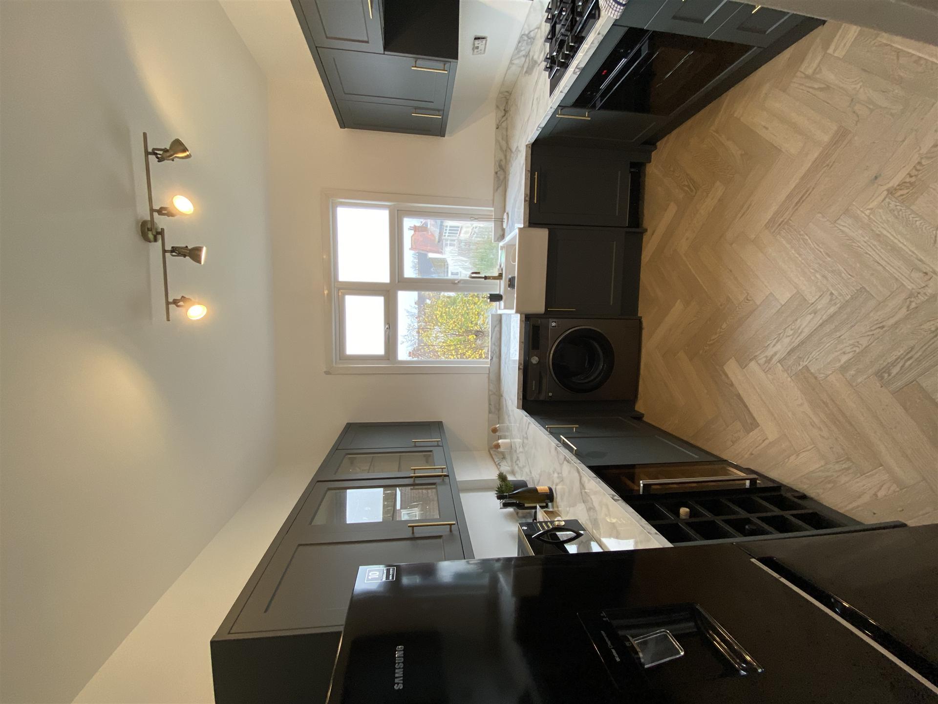 Dark charcoal kitchen with marble worktops, Essex